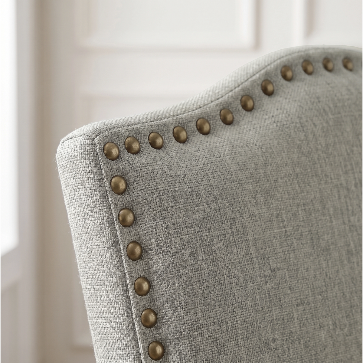 [Light Grey | Set of 4] Close-up detail of bronze nailhead trim on Light Grey fabric dining chair back.