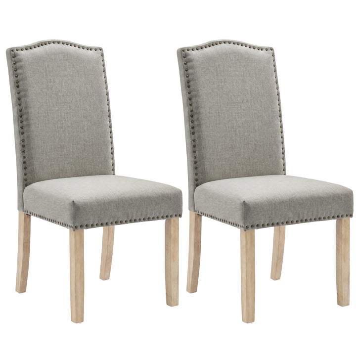 [Light Grey | Set of 2] Two matching upholstered dining chairs with tall arched backs, light grey fabric, nailhead trim, and natural wood legs on a white background.