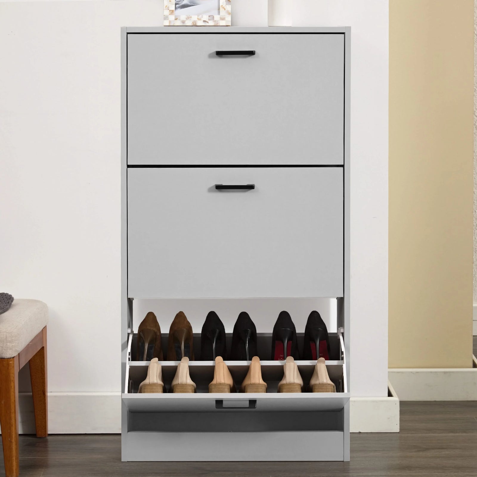 [Light Grey] Front view of grey tall shoe cabinet with bottom drawer open. Slim hallway shoe storage with flip drawers for 18 pairs.