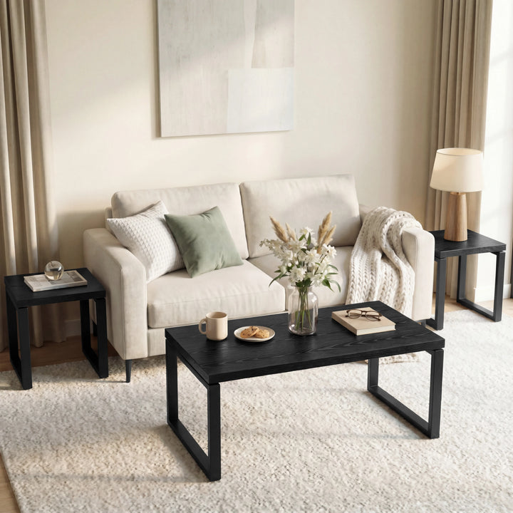 [Black] Nestline nesting coffee table set styled in a soft room with beige chairs, curtains, framed art, and rug