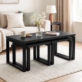 [Black] Nestline nesting coffee table in a bright lounge with cream sofa, glass vase flowers, books, and nested frames