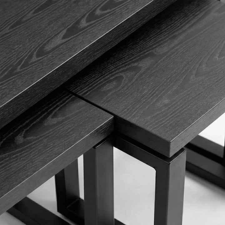 [Black] Nestline nesting coffee table view showing black wood grain top crossing over the square black side nesting table