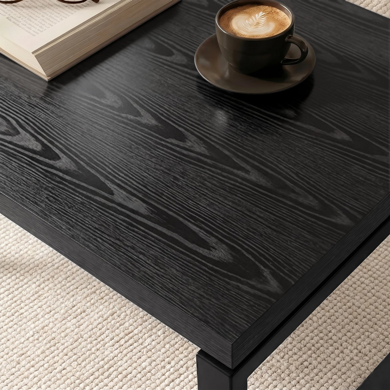 [Black] Nestline nesting coffee table tabletop detail with a small cup on dark wood grain and softly bevelled edge
