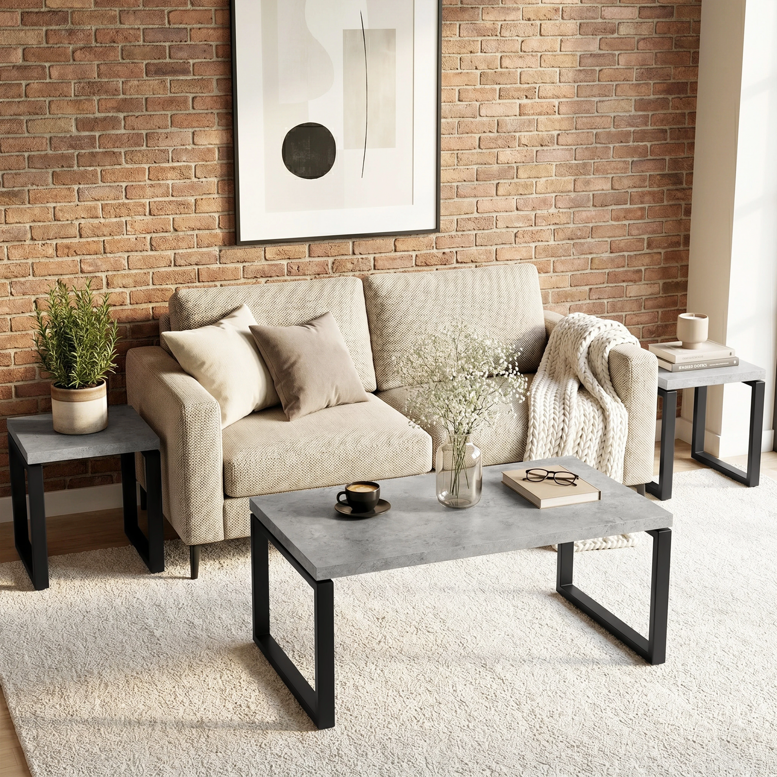 [Concrete] Nestline nesting coffee table styled in a calm room with beige chairs, brick wall, framed art, and rug
