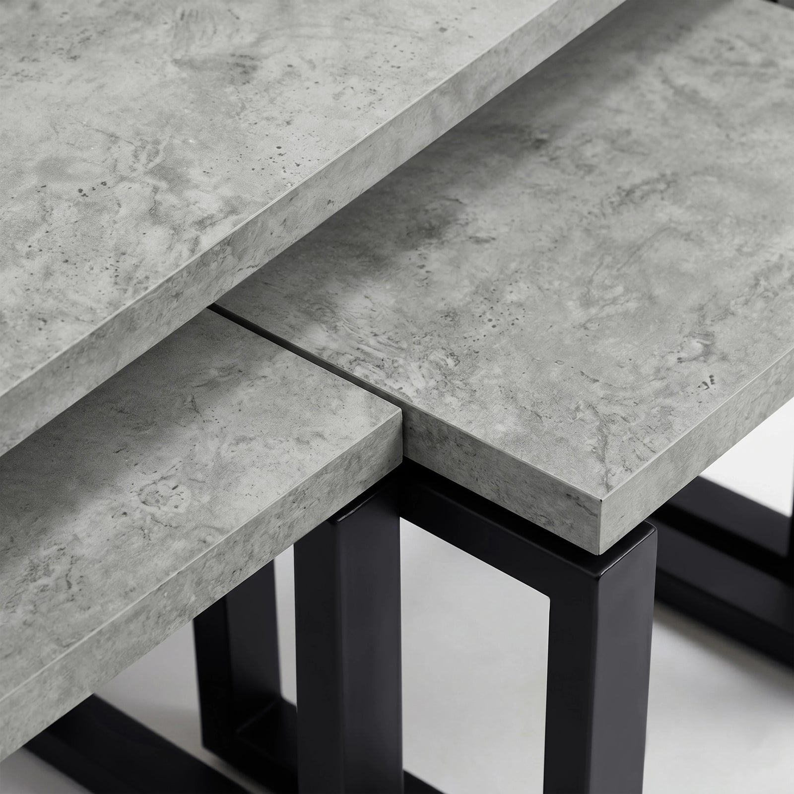 [Concrete] Nestline nesting coffee table showing grey stone-effect top meeting the square black metal support frame