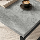 [Concrete] Nestline nesting coffee table tabletop closeup of detail with a dark cup on grey stone texture and softly bevelled