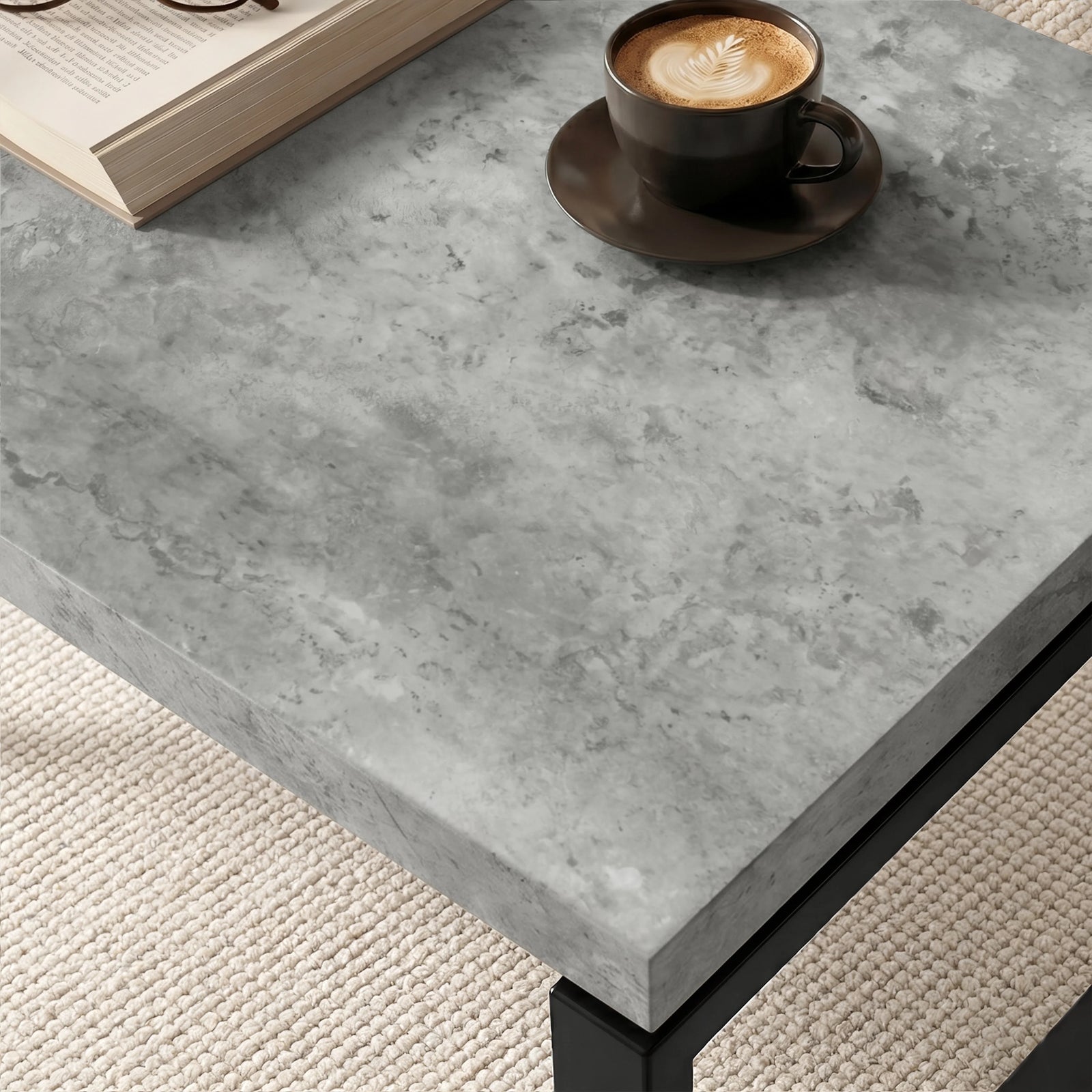 [Concrete] Nestline nesting coffee table tabletop closeup of detail with a dark cup on grey stone texture and softly bevelled