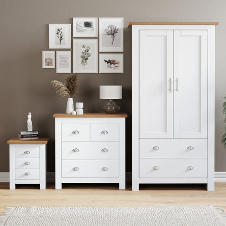 Oak bedroom furniture set with white chest of drawers, bedside table, and wardrobes.