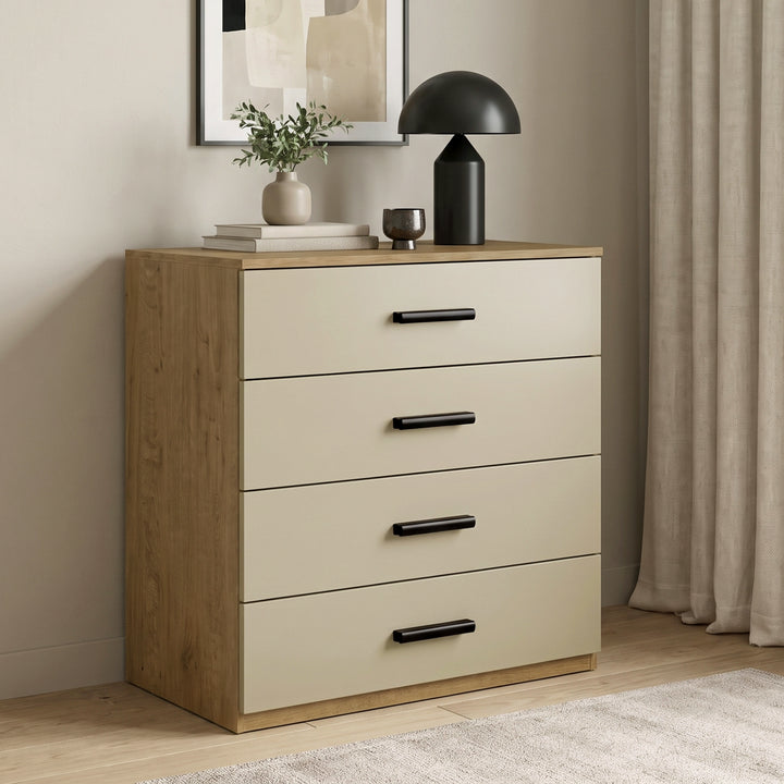 [Oak+Cashmere] Oak and beige 4-drawer storage chest with black handles styled with a table lamp and wall art in a modern home