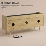[Oak+Black] Rear of TV unit showing three round cable cut outs with black power cable threaded through middle hole