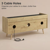 [Oak+Black] Rear of TV unit showing three round cable cut outs with black power cable threaded through middle hole
