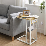 [Oak] sofa side table side view with oak-effect top, socket panel, tea, power cable and storage pouch