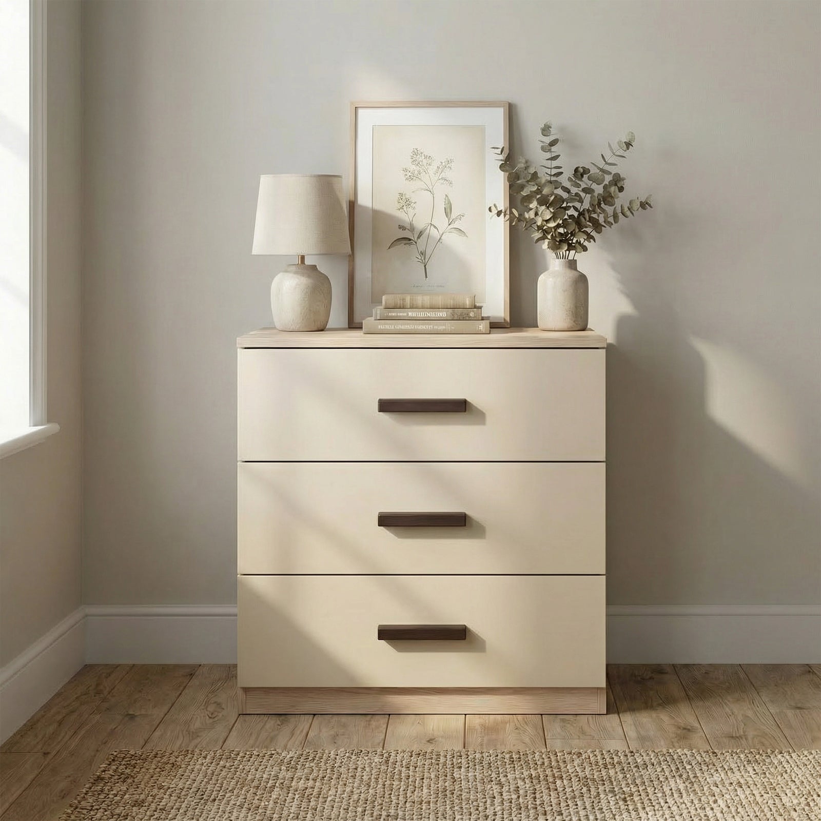 [Oak + Cashmere] Front view of oak cashmere bedroom drawers placed against light wall with black wooden handles in a room