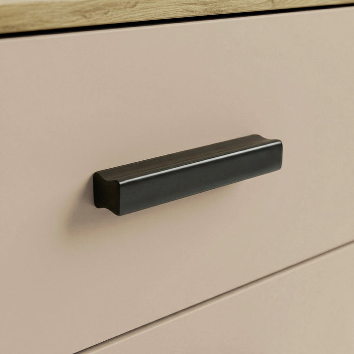 [Oak+Cashmere] Close up of oak and cashmere drawer front with matte black wooden handle of five chest of bedroom drawers