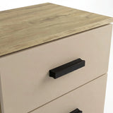 Close up of oak wood top surface and black horizontal handle on cashmere two drawer bedside table