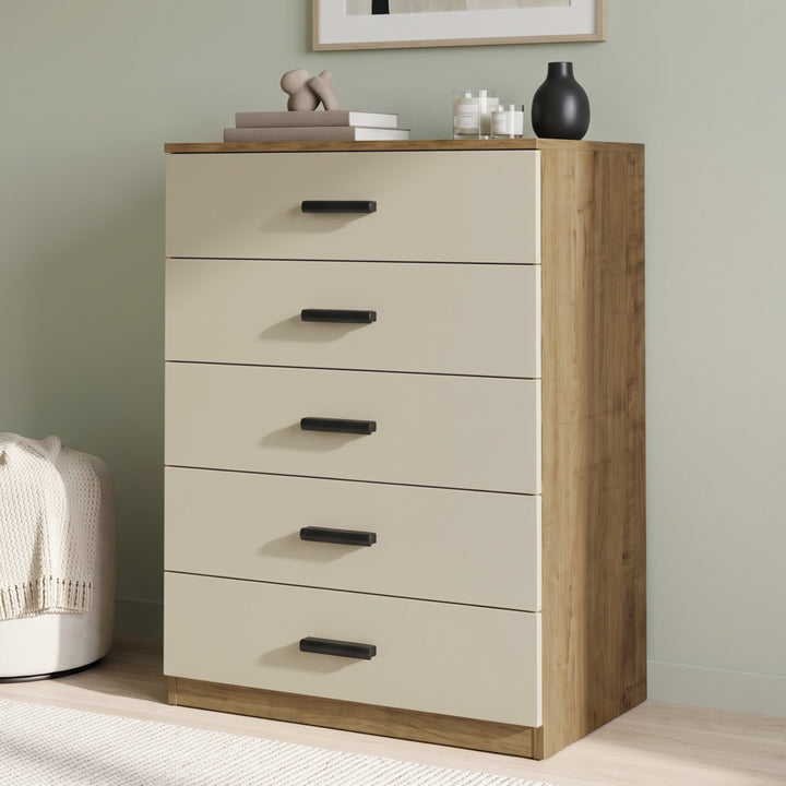[Oak+Cashmere] Angled view of the Oak Cashmere Tall 5 Drawer Chest with cashmere drawers and black handles.