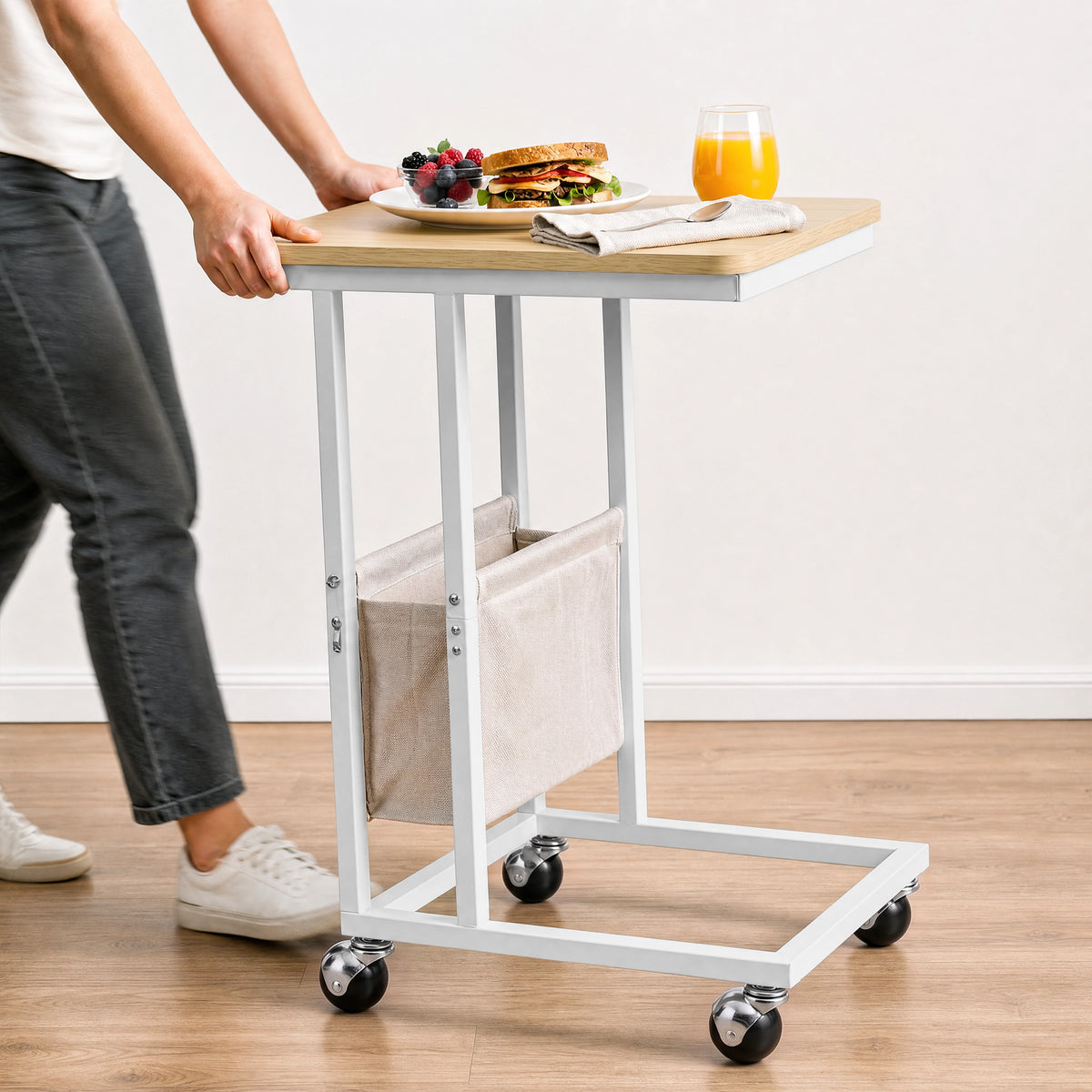 [Oak] movable side table being rolled on caster wheels with snacks and drink on tabletop