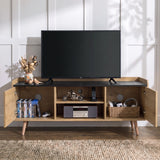 [Oak] TV stand with open side cabinets and open center shelves, styled with a black TV, DVDs, a motorcycle model, a radio, and a basket on a woven rug in a bright room.