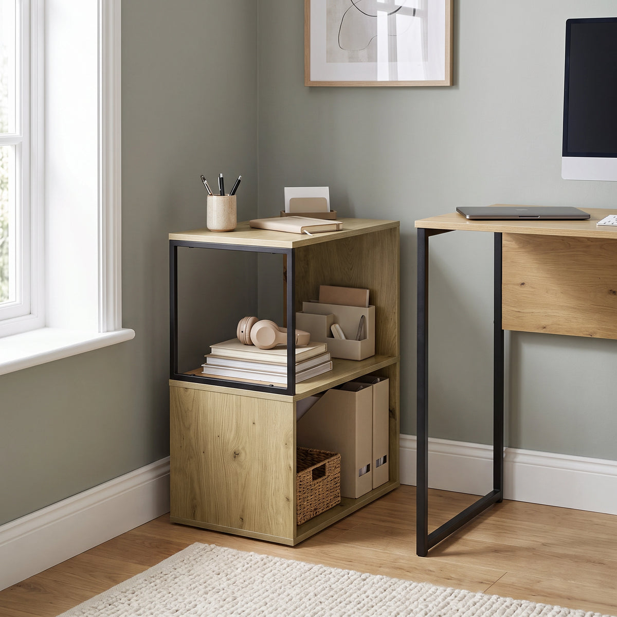 [Oak] This narrow side table stands beside a desk with stationery, headphones, books and storage boxes.
