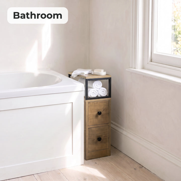 [Oak] Narrow side table with storage beside a bath, holding towels and toiletries
