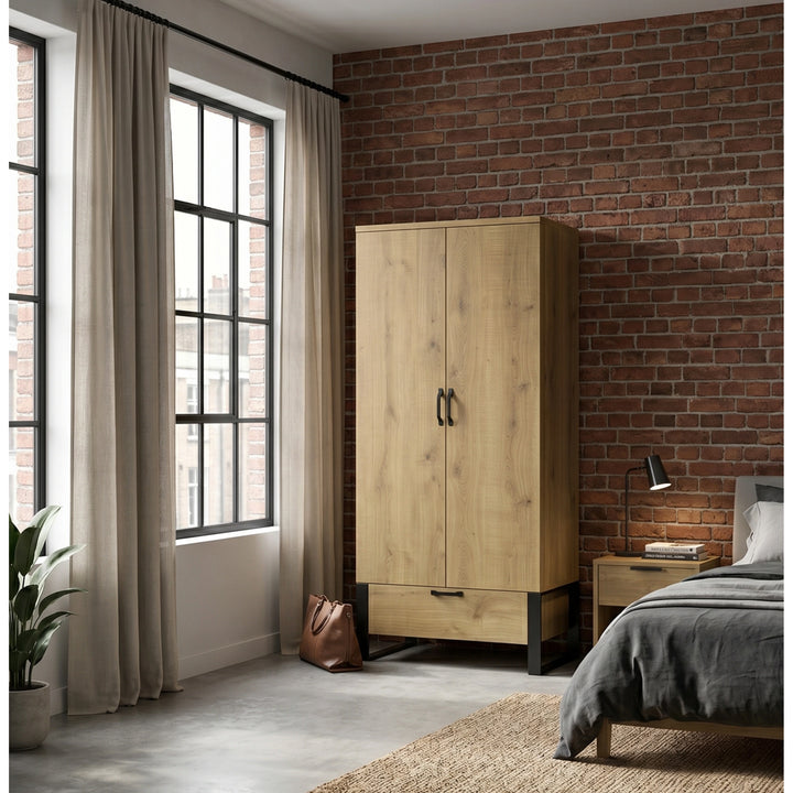 [Oak Effect] Rustvale wardrobe in bedroom with closed doors, lower drawer, brick wall, window, bed, plant, and bag.