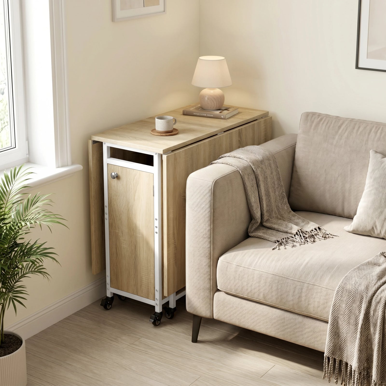 [Sonoma Oak] Kitchen & Dining Furniture Sets folded table parked beside a sofa with lamp, cup, blanket, and window light.