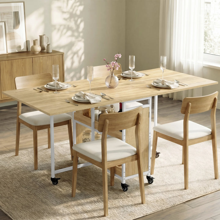 [Oak Effect] Stovra dining scene with oak effect table surface, white frame, central shelves, cupboard, and casters