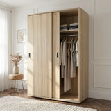 [Oak Effect] Torvek sliding wardrobe half-open in bright bedroom showing hanging rail, upper shelf and folded clothes
