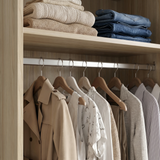 [Oak Effect] Torvek wardrobe interior close-up showing chrome hanging rail with clothes and upper shelf with folded items