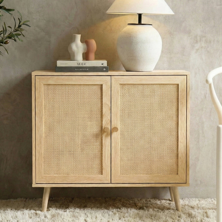 [Oak Effect] Wovena sideboard front angle on rug, two rattan doors closed, lamp and three small vases on top