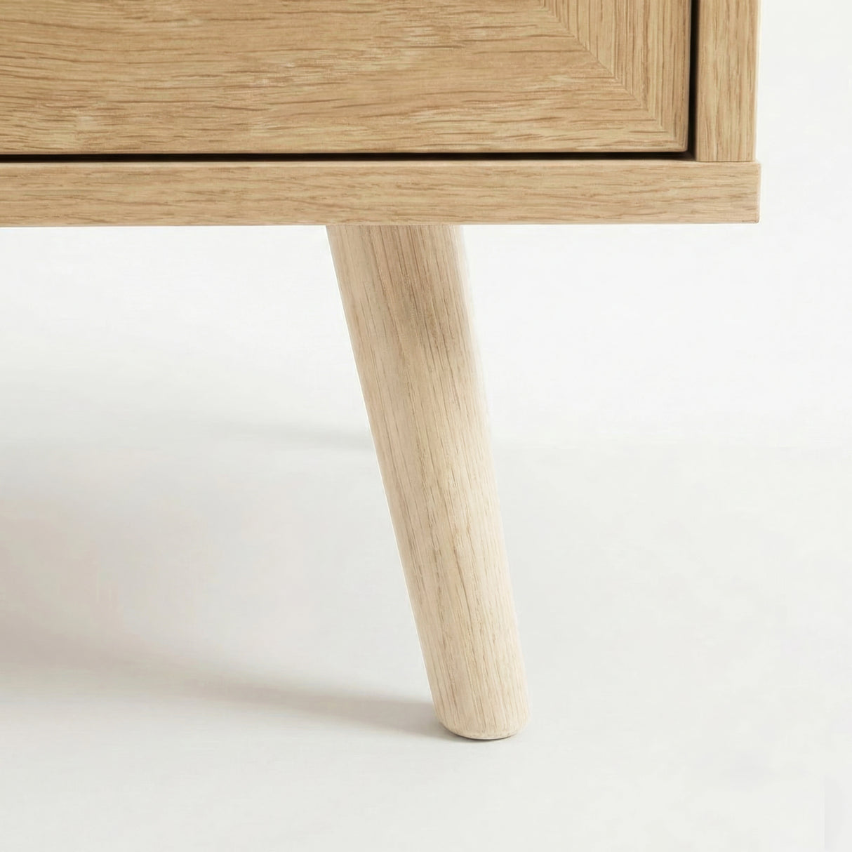 [Oak Effect] Wovena sideboard close up of a tapered round pine leg meeting the mitred oak effect base corner