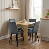 [Oak] Closed flip-top dining table with four grey chairs and tea set in a bright open-plan kitchen diner