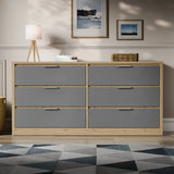 Two-tone finish wide chest of drawers placed in a bright room with a patterned rug and lamp