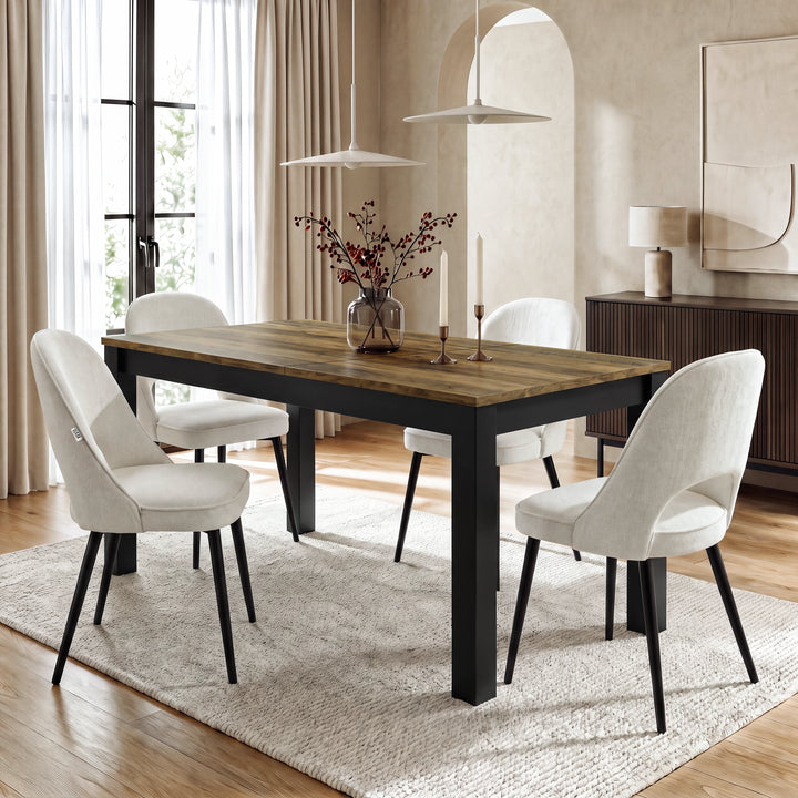 [140cm | Oak] Closed table in bright dining room with four cream chairs, vase, candles, rug, and window light