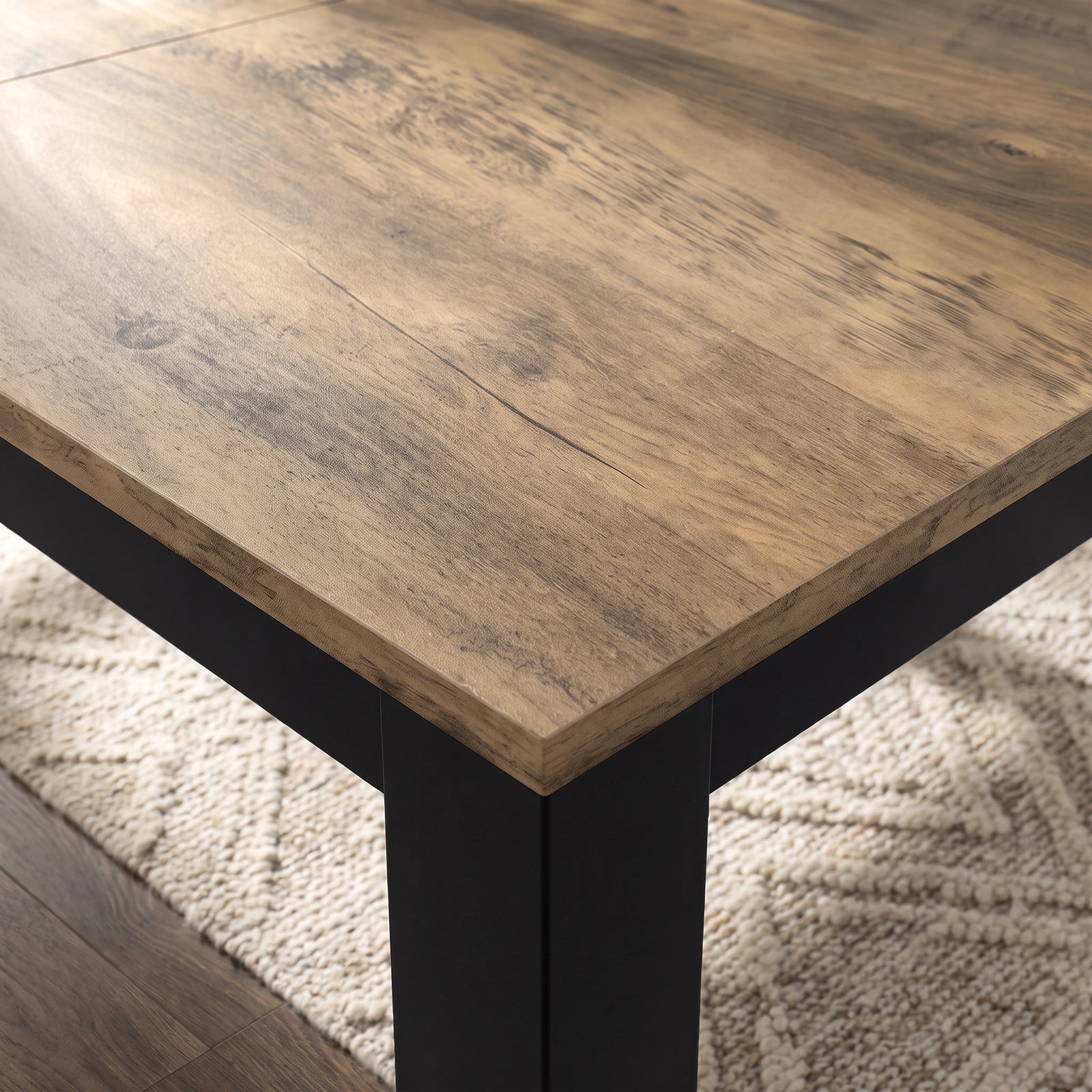 [140cm | Oak] Close-up of 18mm oak wood-effect extendable tabletop and edge, black iron frame and thick square leg.