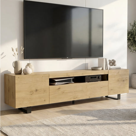 [Oak] Kystra TV stand in a bright Scandi-style living room with a wall-mounted TV above, open centre shelf with AV equipment, ceramic vases and decorative objects on top