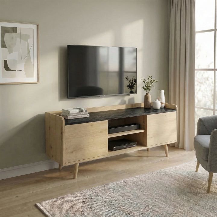 [Oak] Larvik styled in a warm beige living room with wall-mounted TV, olive branch vase, stacked books, and grey armchair