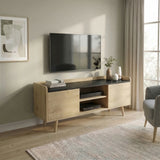 [Oak] Larvik styled in a warm beige living room with wall-mounted TV, olive branch vase, stacked books, and grey armchair