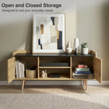 [Oak] Larvik front view with both doors open revealing books, woven basket, soundbar, board games, and cable hole on sage-toned wall