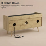 [Oak] Larvik rear panel showing three cable management holes with power cord threaded through on beige background
