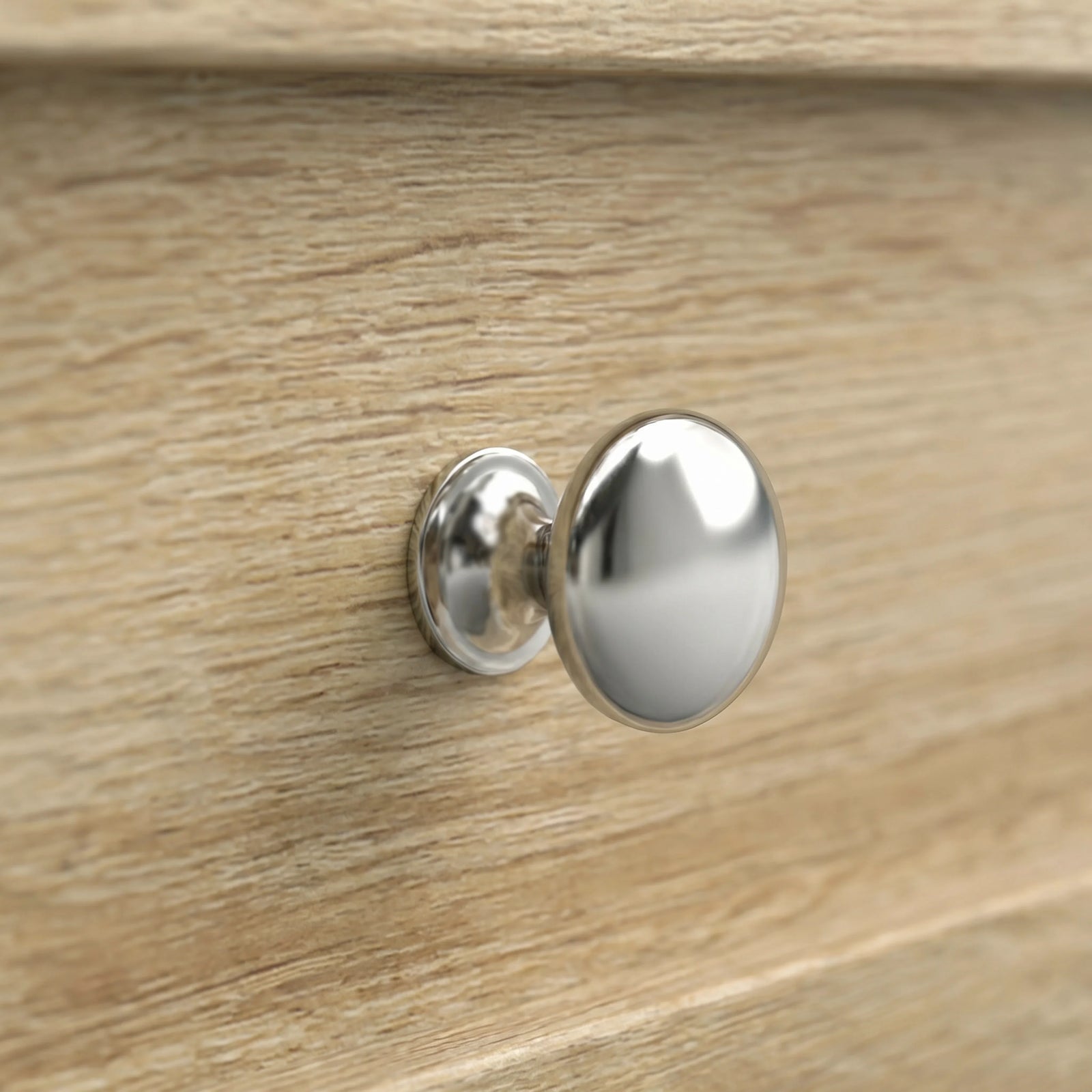 [Oak] Oskara TV Unit with Storage close-up detail of a round polished chrome drawer knob set against the oak effect wood grain panel front