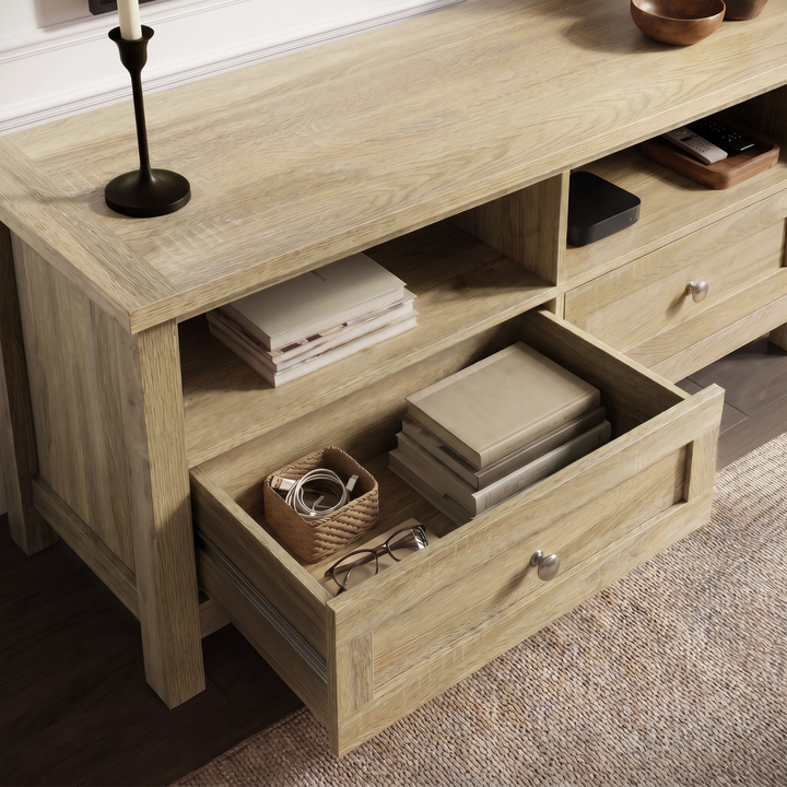 [Oak] Oskara TV unit viewed from above with one drawer open storing cables, glasses, and a wicker tray beside open shelf with books and media device
