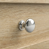 [Oak] Oskara TV unit macro close-up of a polished metallic round drawer knob set against a natural oak grain shaker-style drawer front