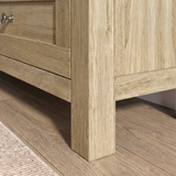 [Oak] Oskara TV unit close-up of solid square oak-effect leg construction and shaker drawer front detail on light wood flooring with jute rug