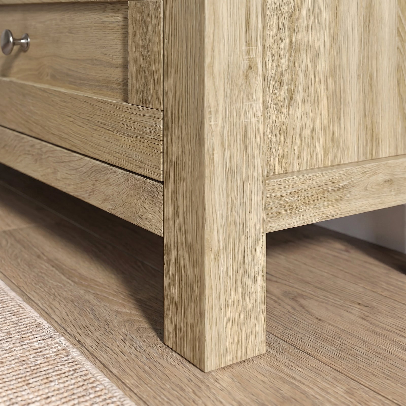 [Oak] Oskara TV Unit with Storage close-up of the lower corner showing the solid square oak effect leg, drawer front panel and base rail construction