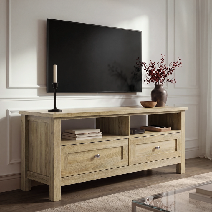 [Oak] Oskara TV unit in a bright living room below a wall-mounted TV with open shelves holding books and media device beside red berry vase