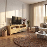 [Oak] Oskara TV Unit with Storage in oak effect finish styled in a bright living room with a TV above, open shelving, two drawers and a jute rug in the foreground