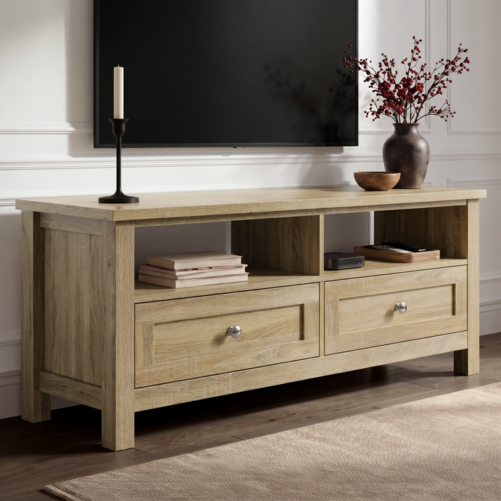 [Oak] Oskara TV unit angled view in living room below a TV with two open shelves, shaker drawers, candlestick, and red berry vase on oak top