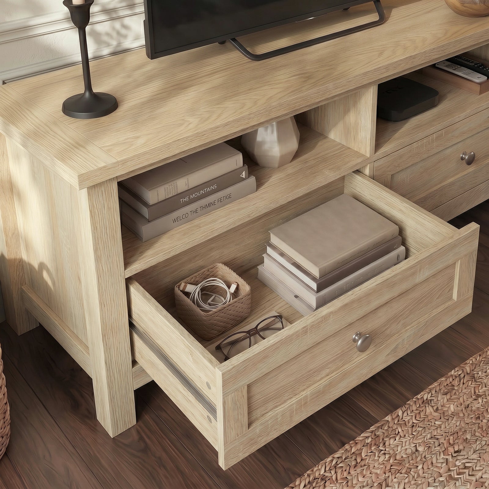 [Oak] Oskara TV Unit with Storage close-up showing left drawer pulled open with books, cables and glasses stored inside alongside an open shelf with stacked books