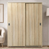 [Oak] Torvek 2 door sliding wardrobe fully closed front view styled in a neutral bedroom with floor lamp